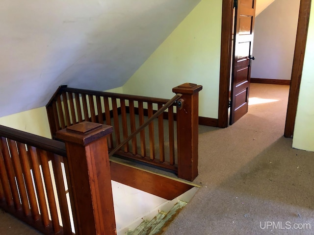 stairs with carpet and vaulted ceiling