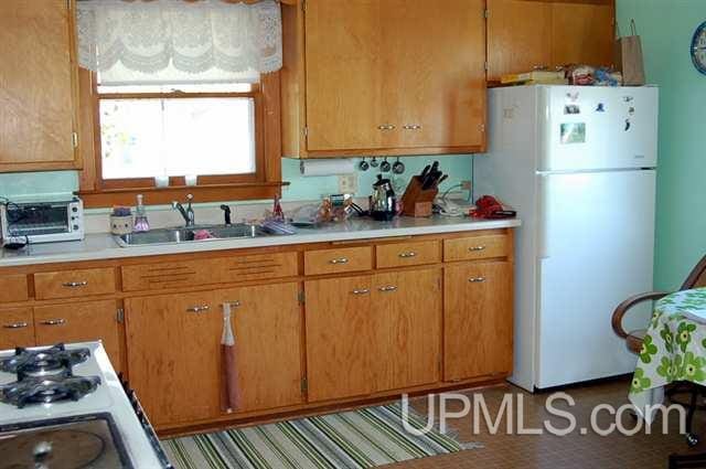 kitchen with sink and white fridge