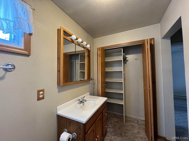 bathroom with vanity and a textured ceiling