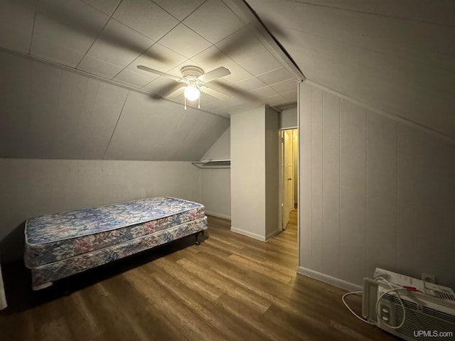 bedroom featuring hardwood / wood-style floors, ceiling fan, and vaulted ceiling