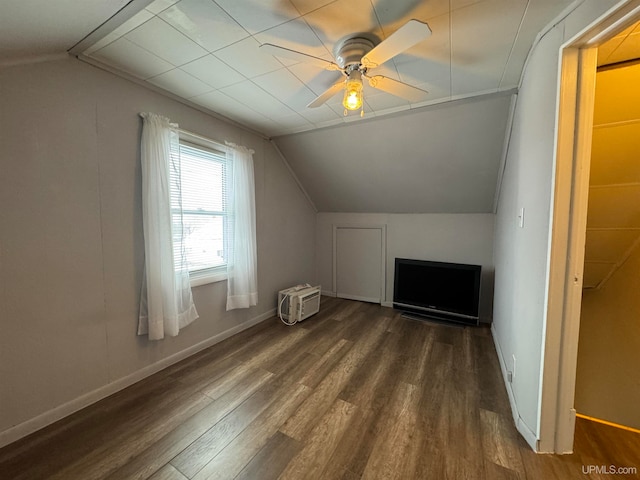 additional living space featuring dark hardwood / wood-style floors, ceiling fan, and lofted ceiling