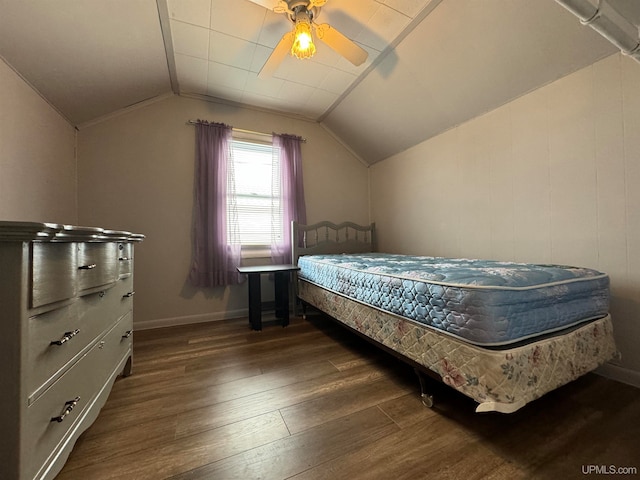 bedroom with ceiling fan, dark hardwood / wood-style flooring, and vaulted ceiling