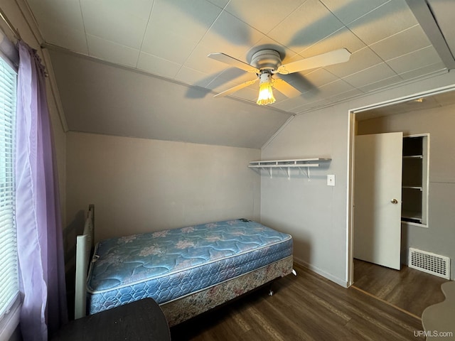 bedroom with lofted ceiling, ceiling fan, and dark wood-type flooring