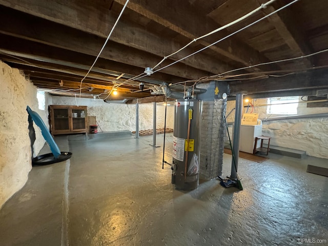 basement featuring gas water heater and washer / clothes dryer