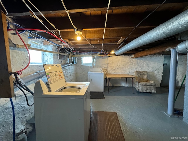 basement featuring a wealth of natural light and washer and clothes dryer