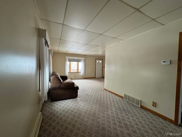 interior space featuring carpet flooring and a paneled ceiling