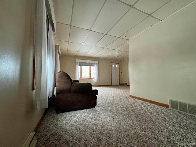 living area featuring a paneled ceiling, carpet flooring, and baseboard heating