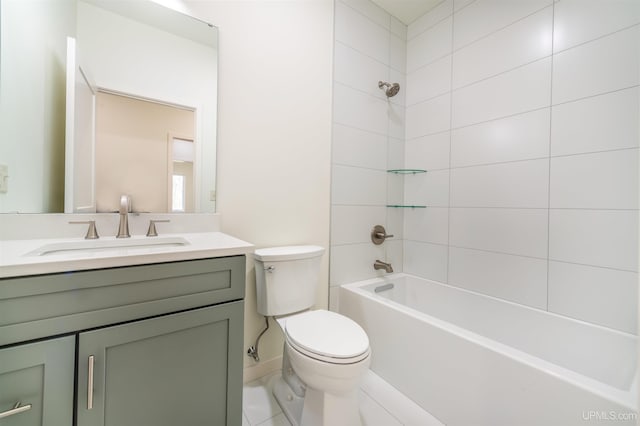 full bathroom featuring tile patterned floors, vanity, tiled shower / bath combo, and toilet