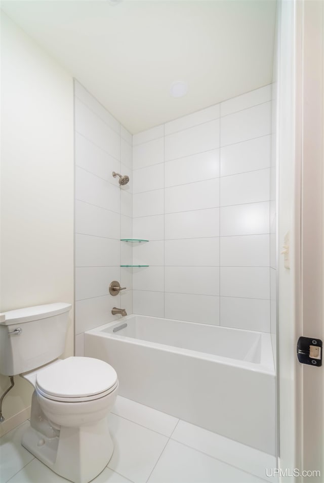 bathroom featuring tile patterned flooring, tiled shower / bath combo, and toilet