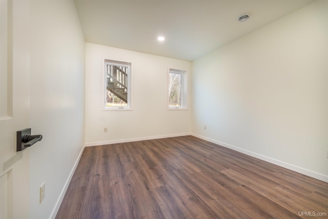 empty room featuring dark hardwood / wood-style flooring