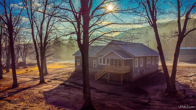 view of back house at dusk