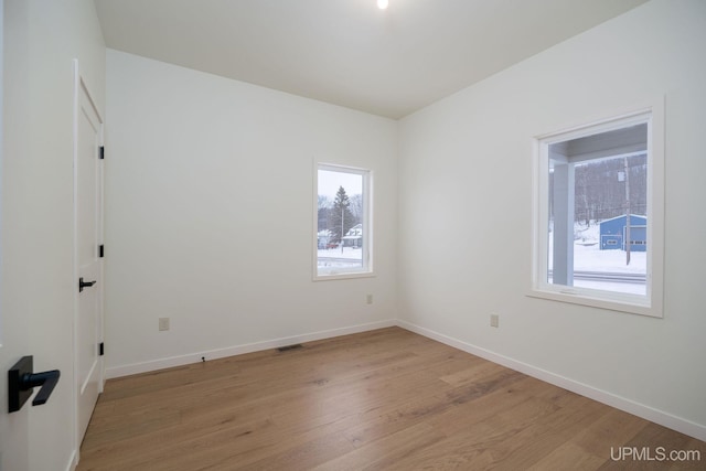 unfurnished room with light hardwood / wood-style floors