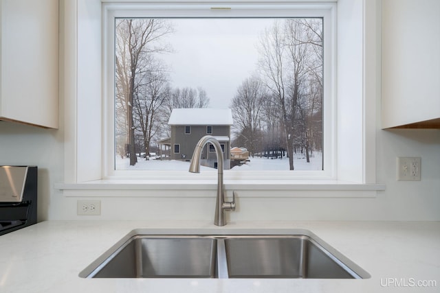 details featuring white cabinetry and sink