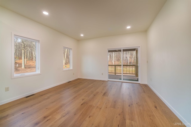 spare room with light hardwood / wood-style floors