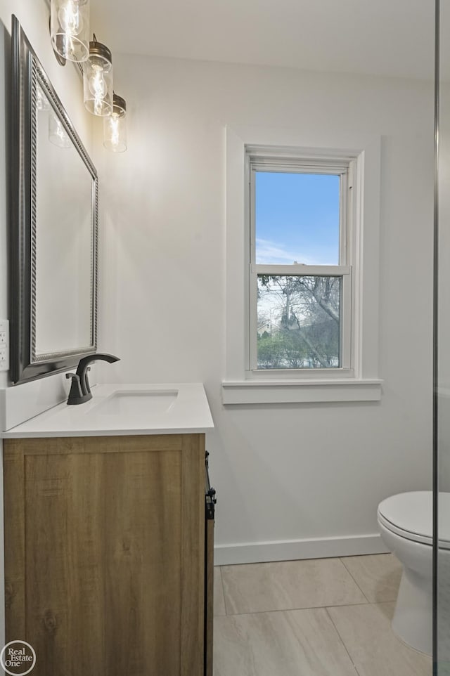 bathroom featuring tile patterned flooring, vanity, and toilet