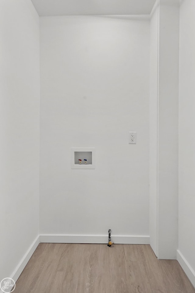 laundry room with hookup for a washing machine and light wood-type flooring