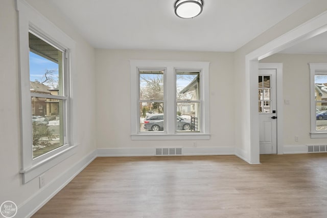 interior space with a wealth of natural light and light hardwood / wood-style floors