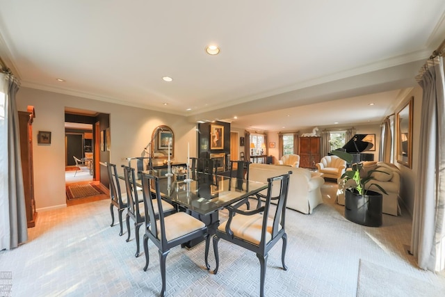 carpeted dining area featuring crown molding