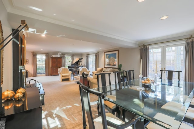 dining room featuring french doors, light colored carpet, and crown molding