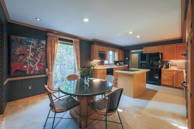 carpeted dining area with crown molding and sink