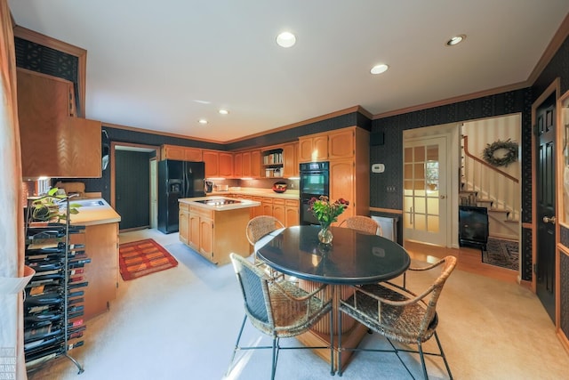 carpeted dining space with ornamental molding and sink