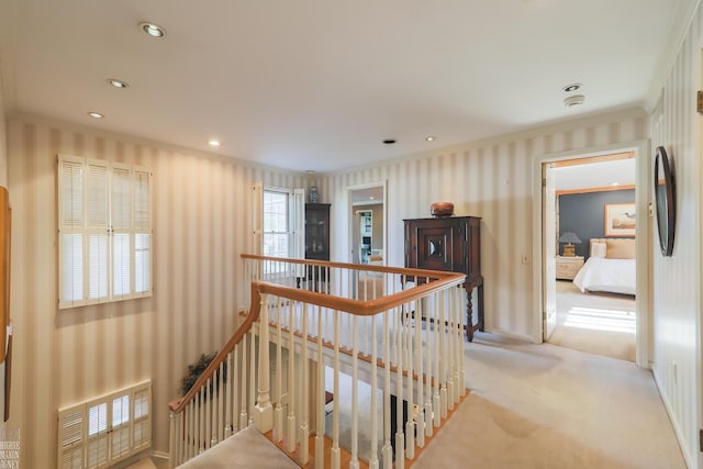 hall featuring light colored carpet and ornamental molding