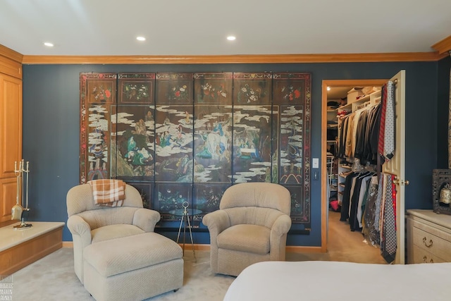 carpeted bedroom featuring a spacious closet, ornamental molding, and a closet