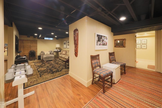 sitting room featuring beamed ceiling and light hardwood / wood-style floors