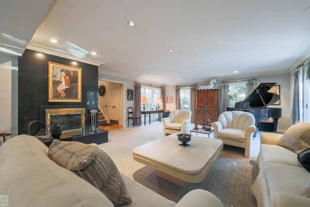 carpeted living room with a wealth of natural light and crown molding