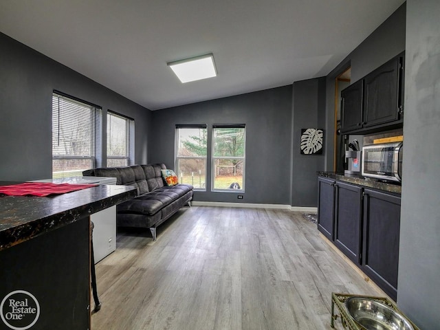 living room featuring light hardwood / wood-style floors and lofted ceiling