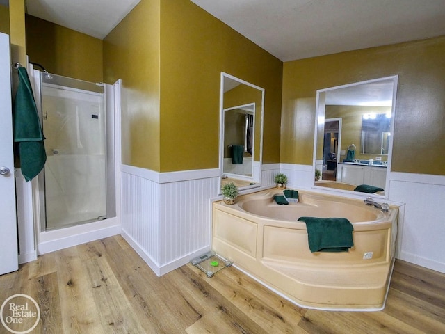 bathroom featuring shower with separate bathtub and hardwood / wood-style flooring