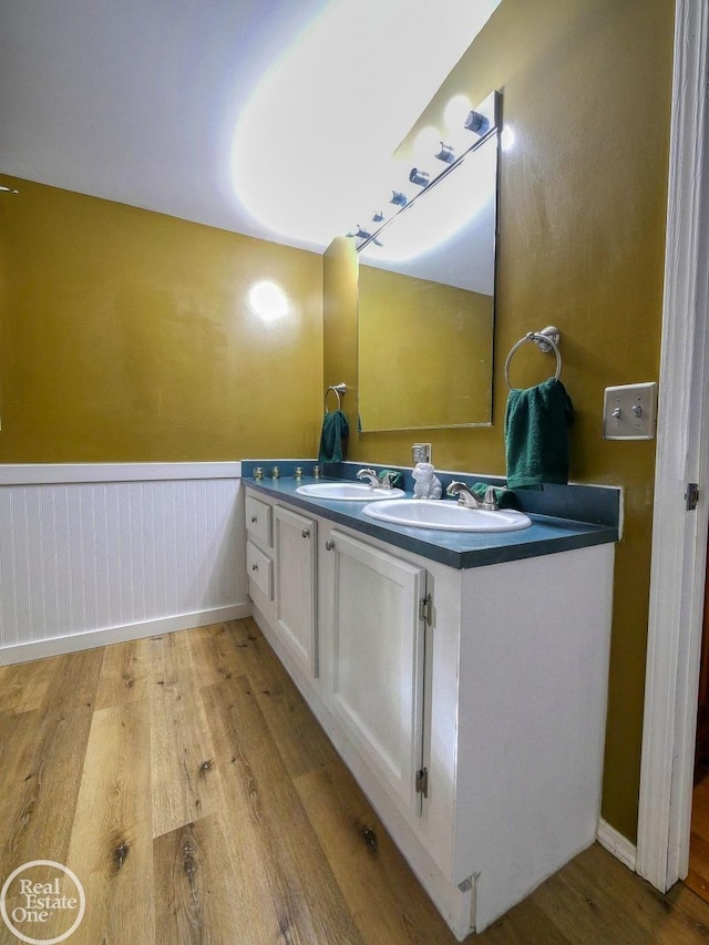 bathroom with vanity and hardwood / wood-style flooring