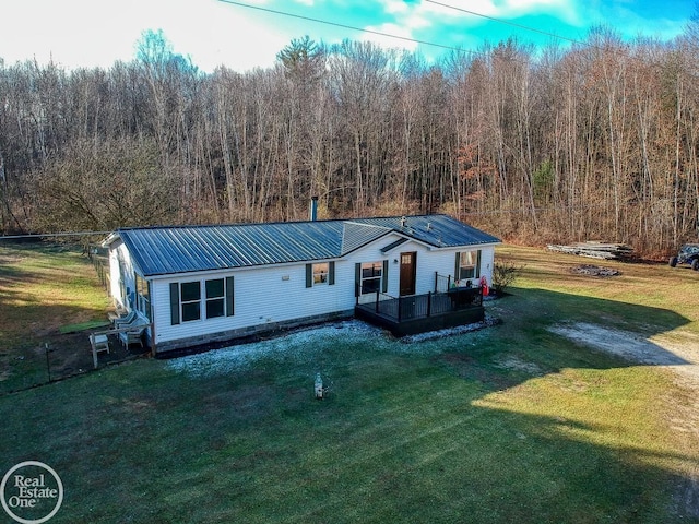 view of front of property with a front yard and a wooden deck