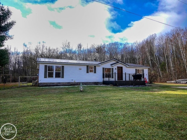 view of front of home with a front lawn and a wooden deck