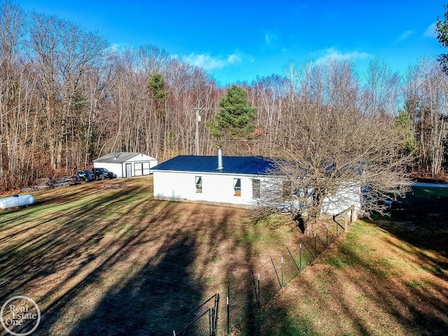 view of property exterior featuring a lawn and an outdoor structure