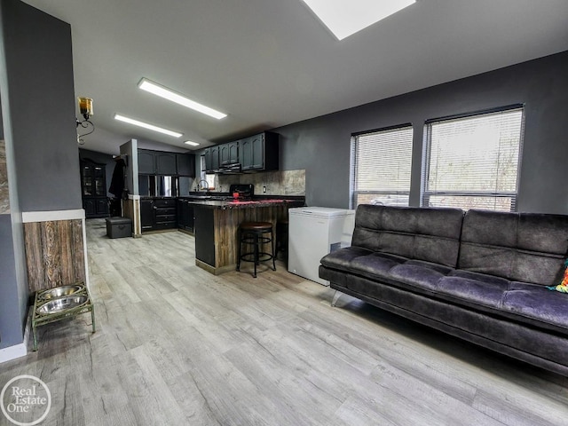 living room featuring light wood-type flooring and sink