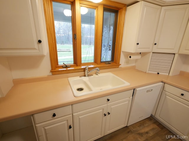 kitchen featuring white dishwasher, white cabinets, sink, and dark wood-type flooring