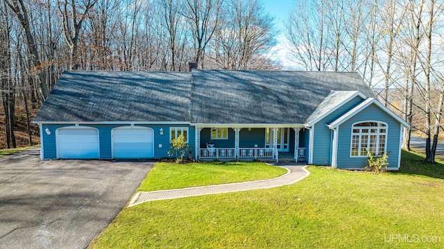 ranch-style house featuring covered porch, a garage, and a front yard