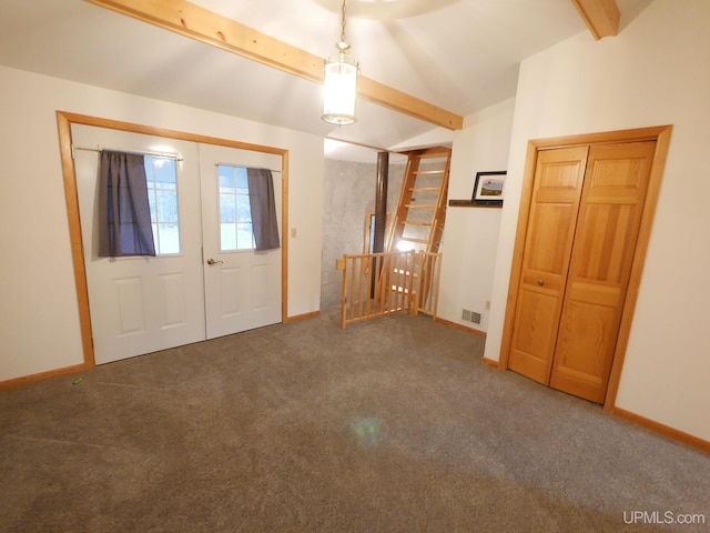 entryway with french doors, lofted ceiling with beams, and dark colored carpet