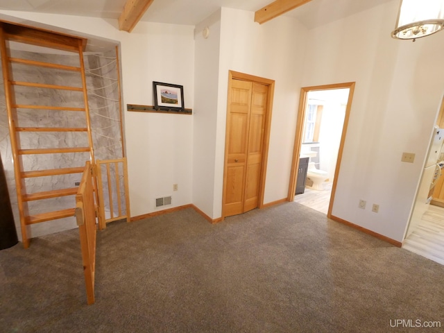 interior space with lofted ceiling with beams and carpet floors