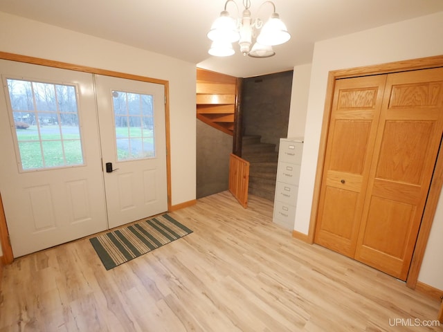 entryway featuring an inviting chandelier and light wood-type flooring