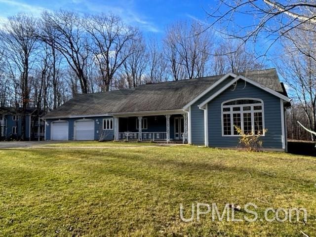 ranch-style house with a porch, a garage, and a front yard