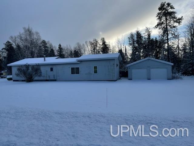 exterior space with an outbuilding and a garage