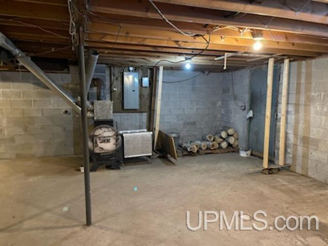 basement featuring electric panel