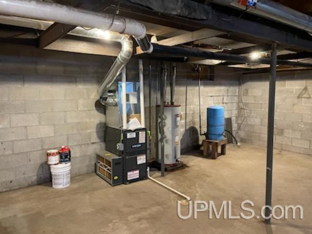 basement featuring heating unit and water heater