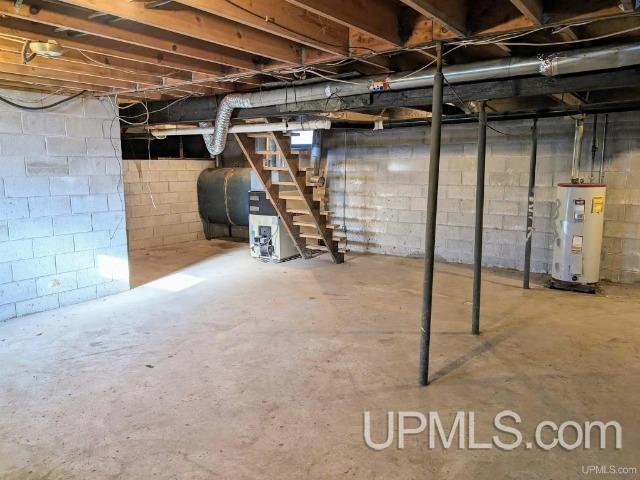 basement featuring electric water heater