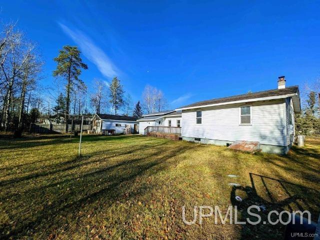 back of property featuring a lawn