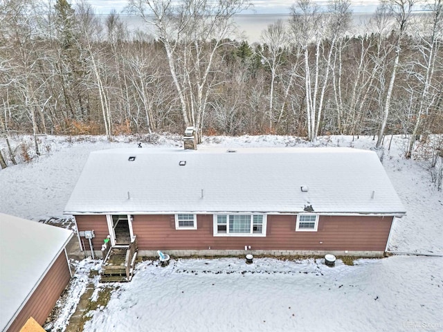 view of snow covered rear of property