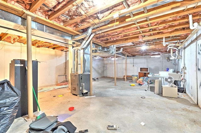 basement featuring heating unit and washer / clothes dryer