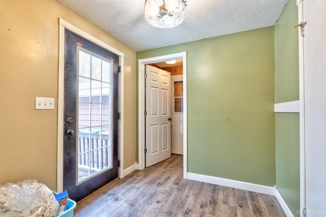 entryway featuring light hardwood / wood-style flooring and a textured ceiling